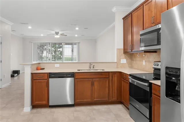 a kitchen that has a sink and a stove top oven