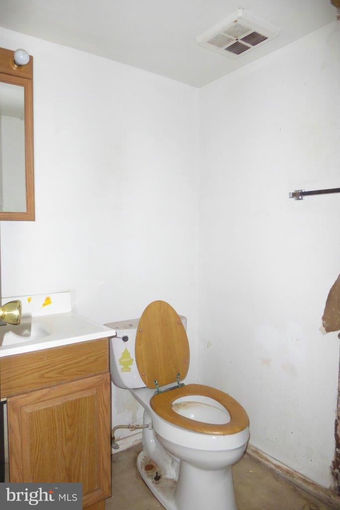 7957 Riggs Road, Unit 2 Hyattsville, MD 20783 - Photo 9 of 17 a bathroom with a sink a toilet and a mirror