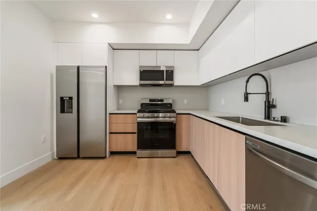 a kitchen with a refrigerator and a sink