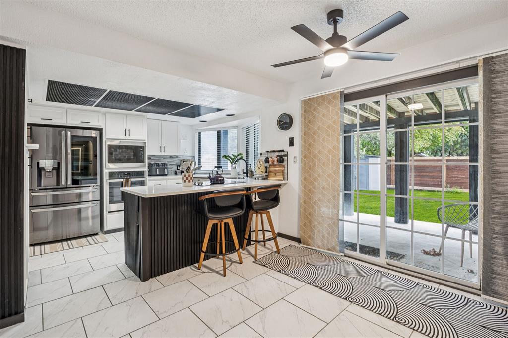 3601 Colosseum Way Grand Prairie, TX 75052 - Photo 14 of 28 a kitchen with a sink a counter top space and appliances