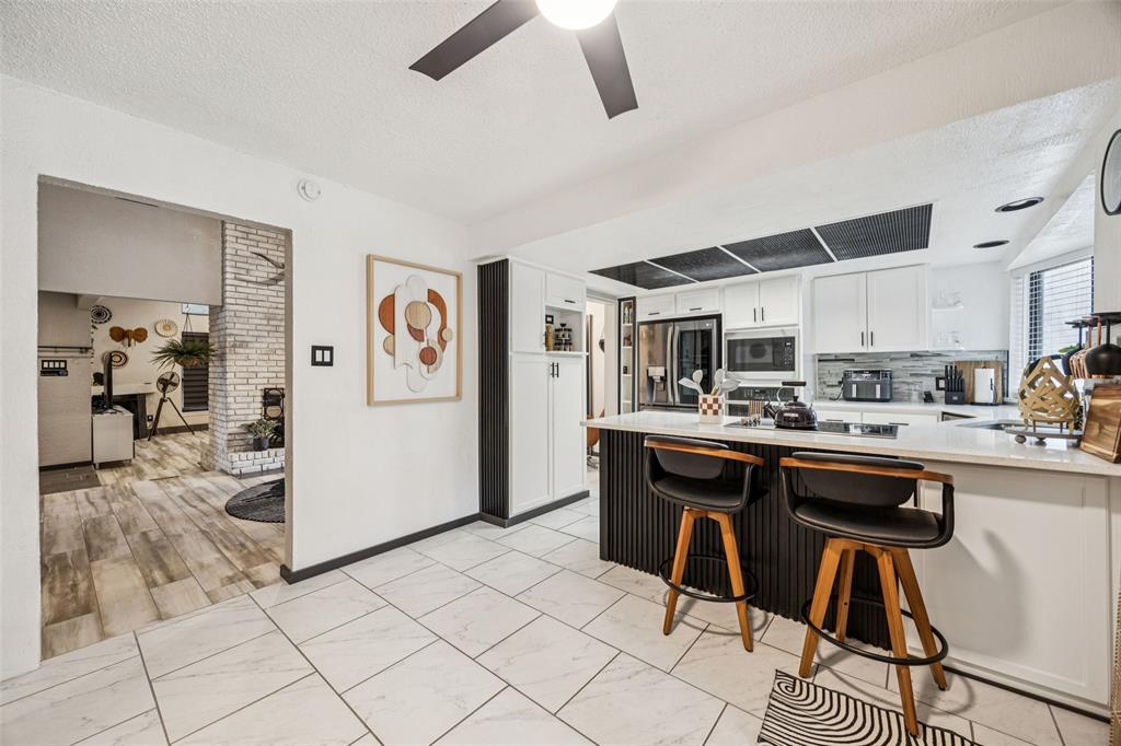 3601 Colosseum Way Grand Prairie, TX 75052 - Photo 16 of 28 a kitchen with stainless steel appliances granite countertop a sink and a refrigerator