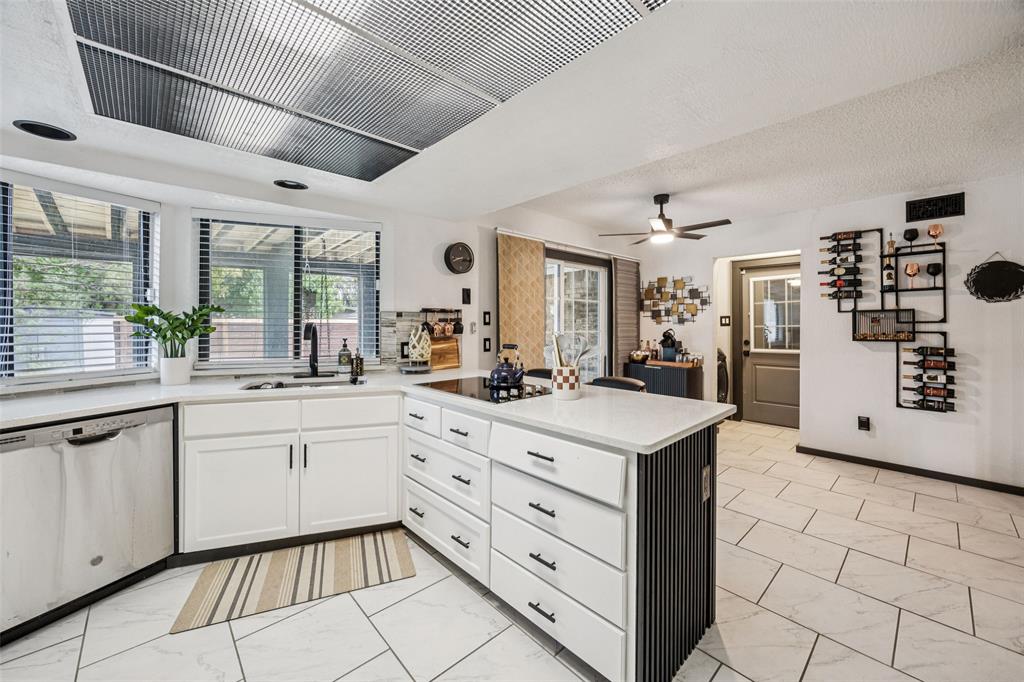 3601 Colosseum Way Grand Prairie, TX 75052 - Photo 18 of 28 a kitchen with granite countertop cabinets a sink and a counter top space