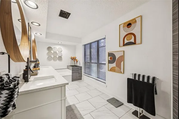 a spacious bathroom with a sink mirror and shower