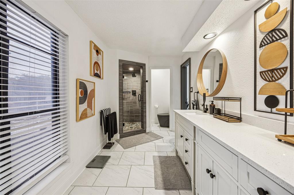 3601 Colosseum Way Grand Prairie, TX 75052 - Photo 21 of 28 a spacious bathroom with a sink mirror and shower