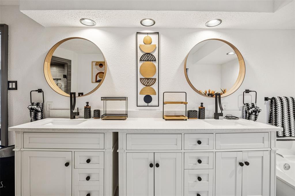 3601 Colosseum Way Grand Prairie, TX 75052 - Photo 22 of 28 a bathroom with a sink and a mirror