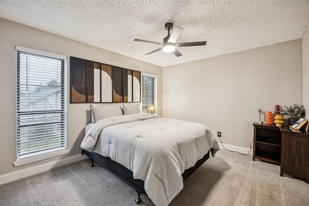 3601 Colosseum Way Grand Prairie, TX 75052 - Photo 25 of 28 a spacious bedroom with a bed and a chandelier
