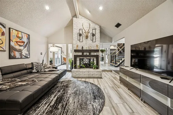 a living room with fireplace furniture and a flat screen tv