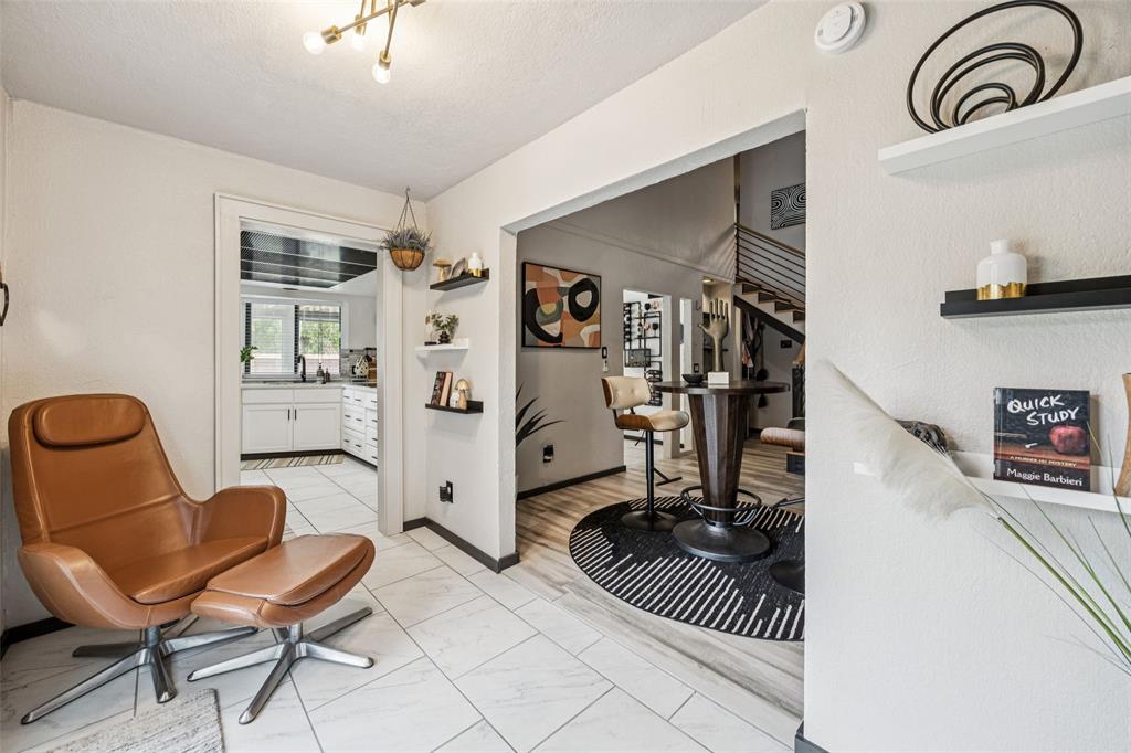 3601 Colosseum Way Grand Prairie, TX 75052 - Photo 6 of 28 a living room with furniture a dining table and a stove top oven