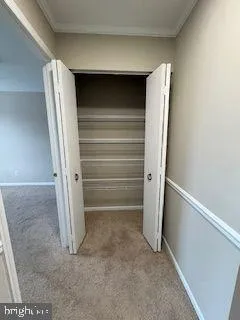 a view of walk in closet with empty racks