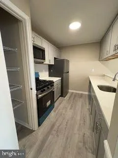 a kitchen with granite countertop a sink and steel appliances