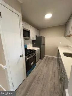 a kitchen with a refrigerator and a sink