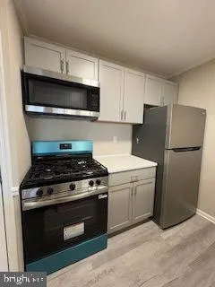 a kitchen with a stove and a refrigerator