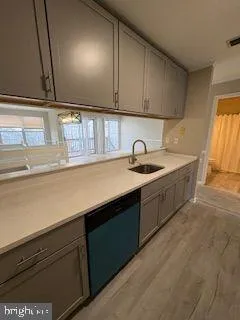 a kitchen with a sink and cabinets