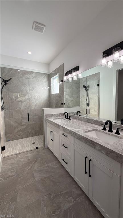 4710 Acadia Lane Naples, FL 34112 - Photo 6 of 10 a spacious bathroom with double sink and a mirror