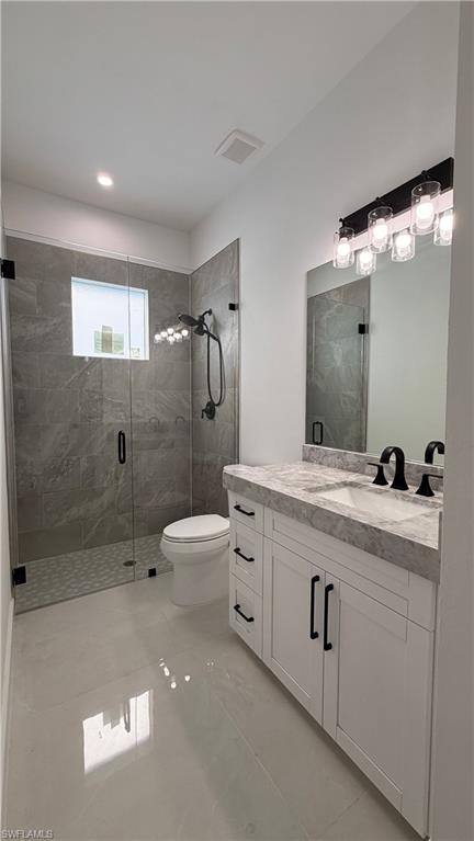4710 Acadia Lane Naples, FL 34112 - Photo 7 of 10 a bathroom with a double vanity sink toilet and shower