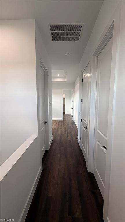4710 Acadia Lane Naples, FL 34112 - Photo 9 of 10 a hallway with wooden floor windows and a bathroom