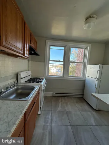 a kitchen that has a sink a stove and window