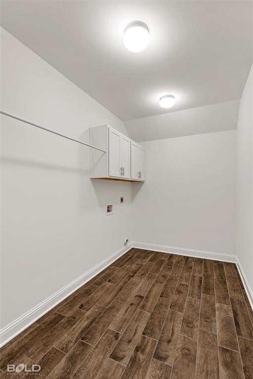 304 Prien Lk Loop Bossier City, LA 71111 - Photo 33 of 39 Laundry room featuring wood-finish flooring, white baseboards, and built-in white cabinetry with chrome hardware
