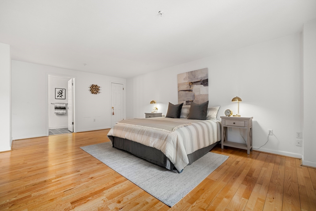 11 Church Street, Unit 203 Salem, MA 01970 - Photo 15 of 40 a bedroom with a bed and a table