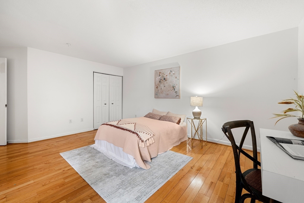 11 Church Street, Unit 203 Salem, MA 01970 - Photo 19 of 40 a bedroom with a bed and wooden floor