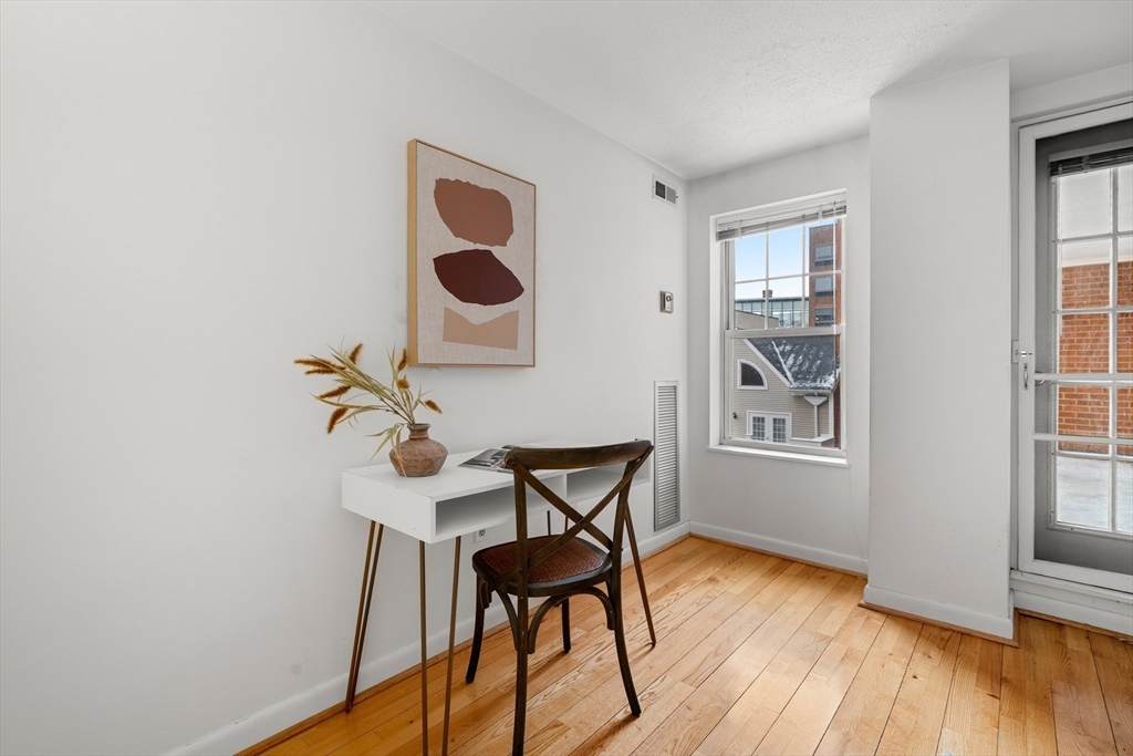 11 Church Street, Unit 203 Salem, MA 01970 - Photo 20 of 40 a view of a workspace room with wooden floor and windows