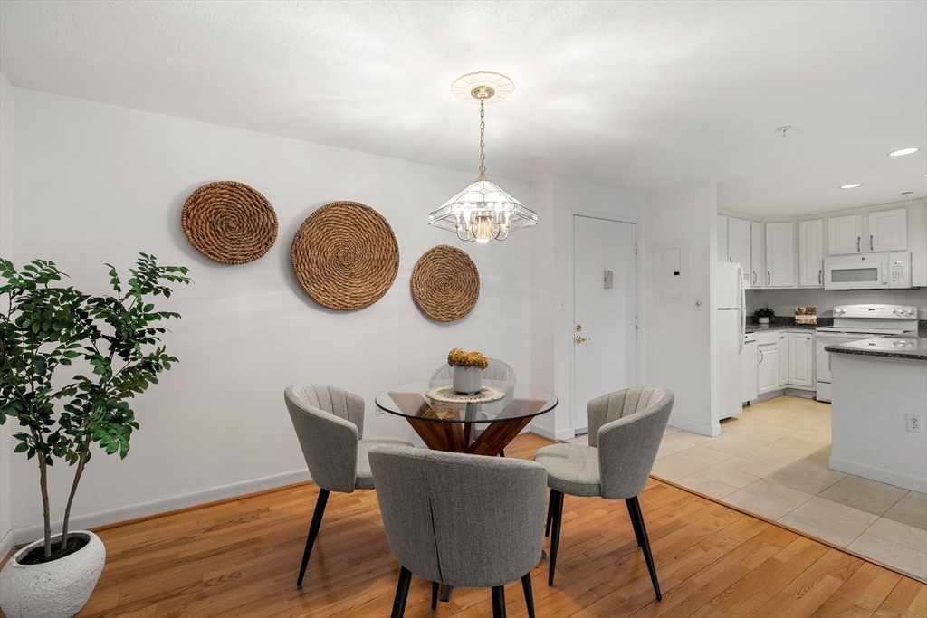 11 Church Street, Unit 203 Salem, MA 01970 - Photo 4 of 40 a dining room table chair and chandelier