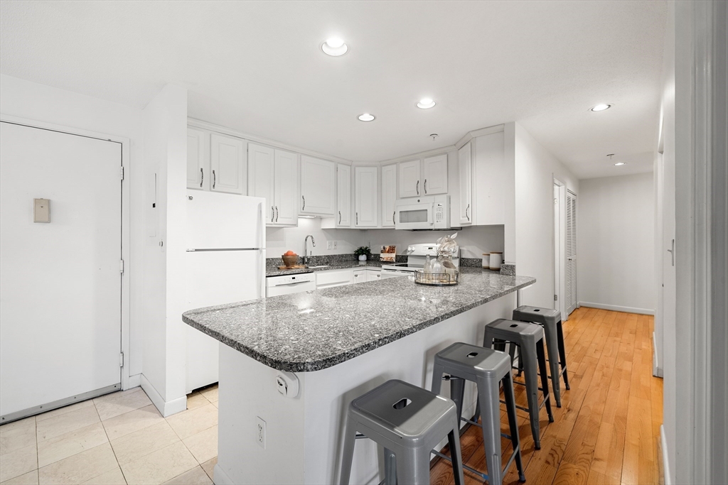 11 Church Street, Unit 203 Salem, MA 01970 - Photo 8 of 40 a kitchen with stainless steel appliances granite countertop a sink and a refrigerator