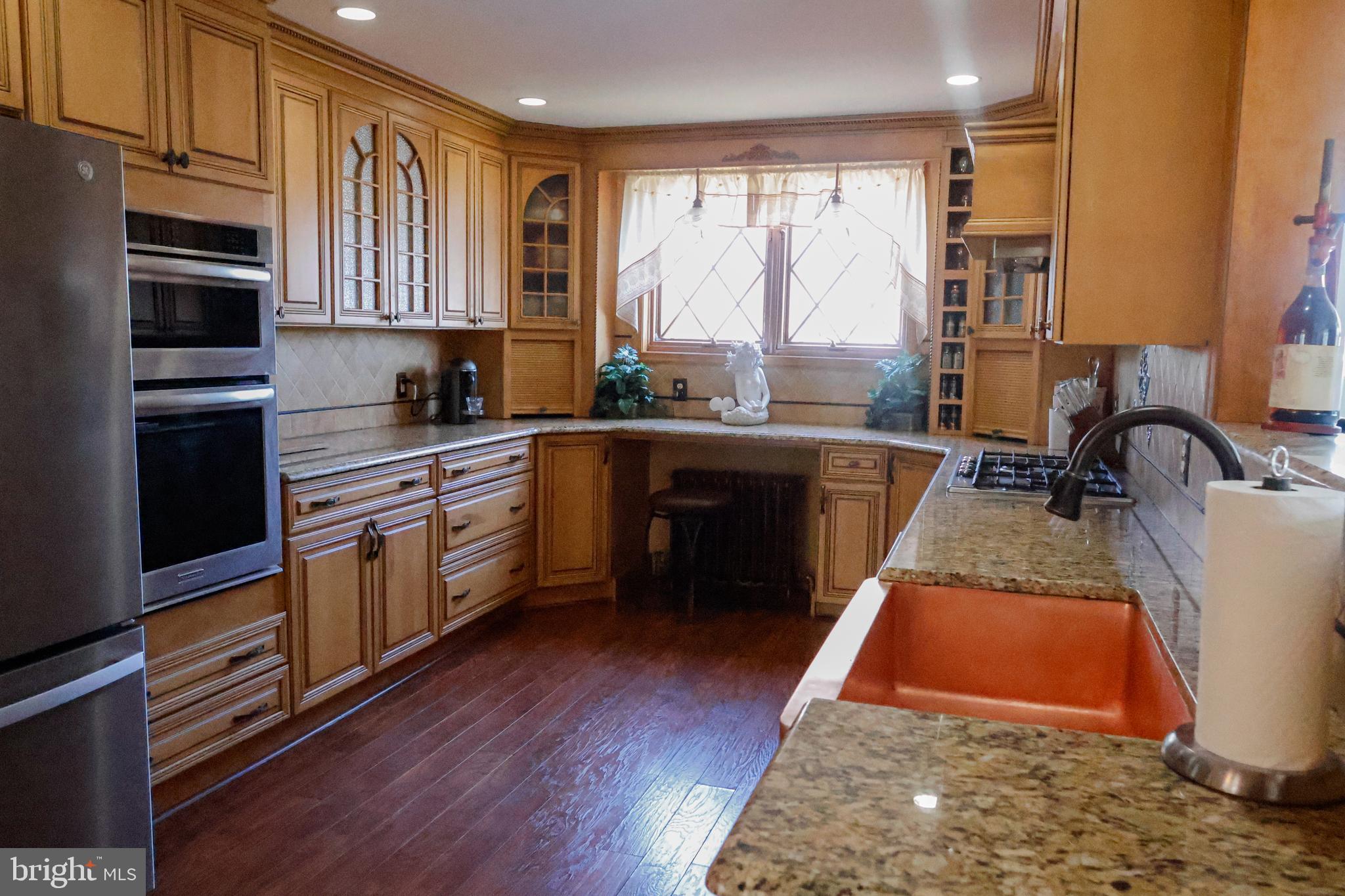 53 Kirkwood Road Gibbsboro, NJ 08026 - Photo 15 of 37 a kitchen with wooden floors sink and stainless steel appliances