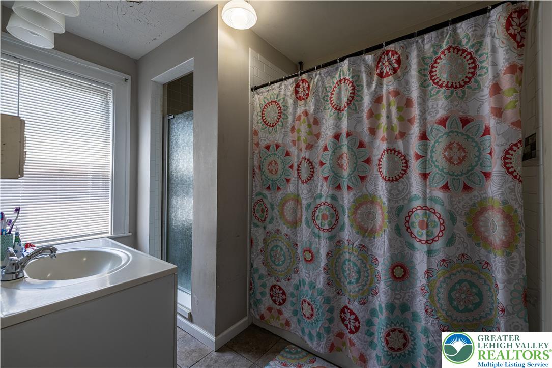 118 South 3rd Street Bangor, PA 18013 - Photo 19 of 33 This bright bathroom features a vanity, shower, and window for a fresh start to your day.