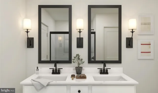 a bathroom with double vanity sinks and a mirror