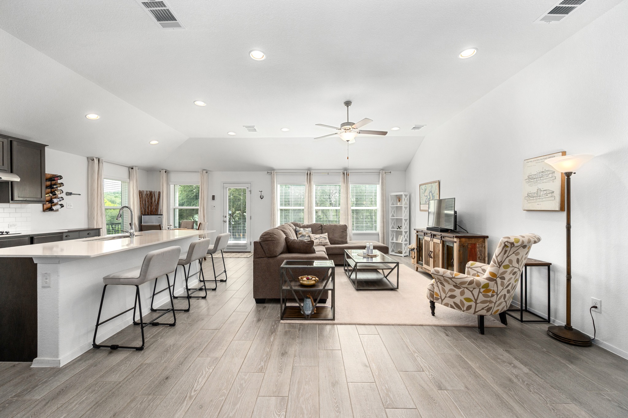 21006 Santa Rosa Avenue Lago Vista, TX 78645 - Photo 26 of 26 An open concept floorplan unites the kitchen and living space, offering generous gathering areas for entertaining.