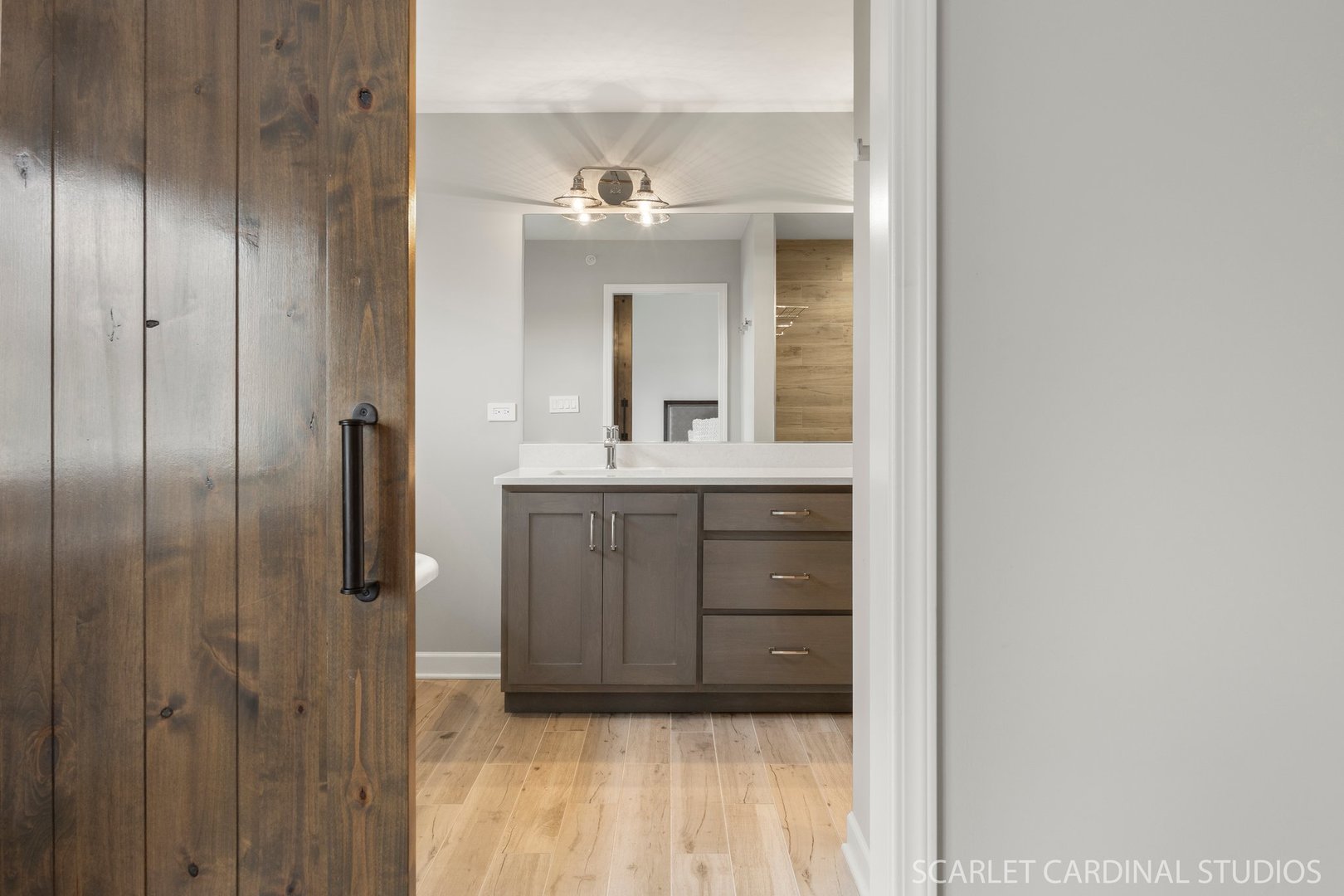 14253 Lacey Drive Lemont, IL 60439 - Photo 16 of 24 a bathroom with a light fixture a mirror and a sink
