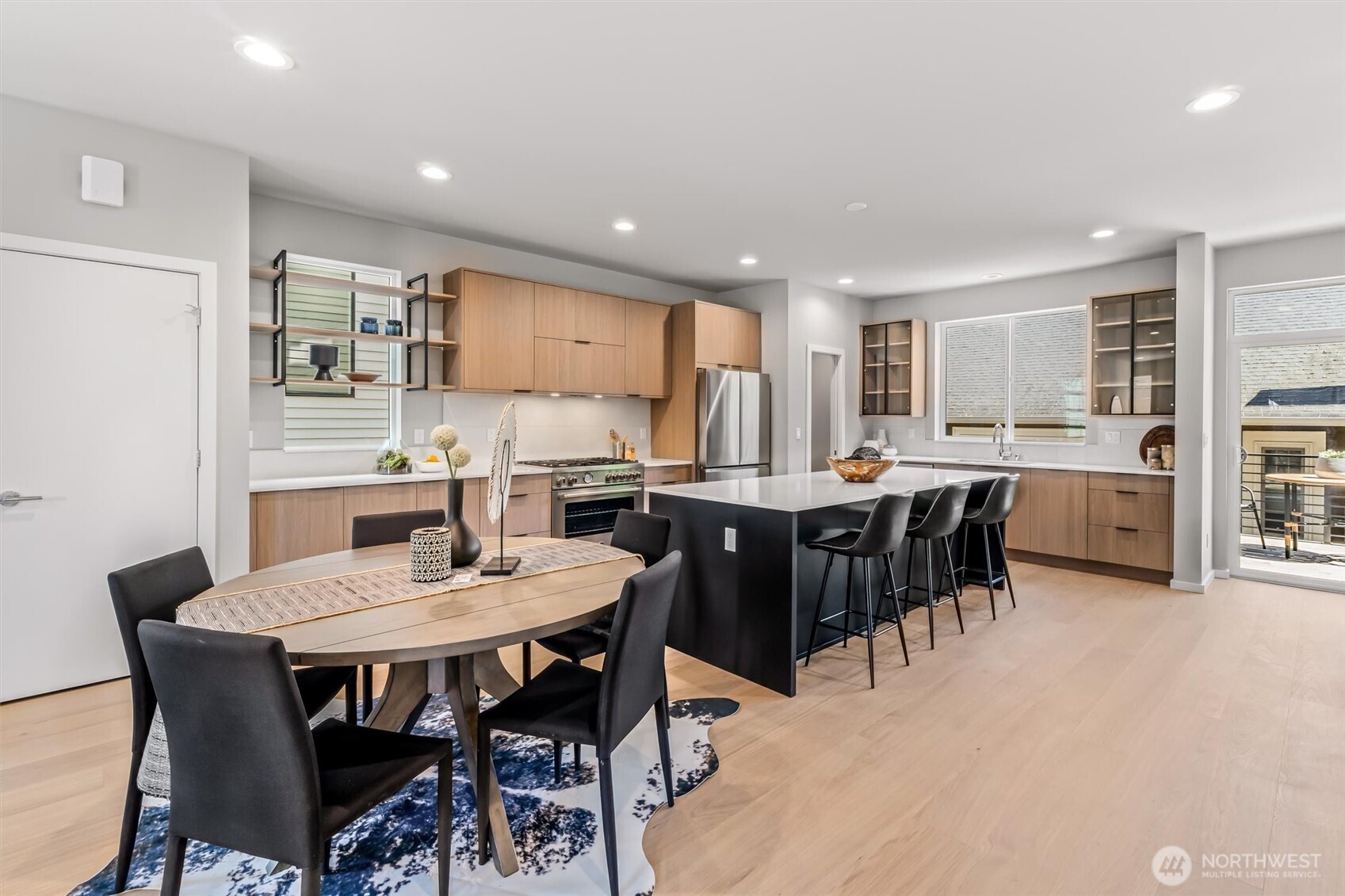 4460 Midvale Avenue North Seattle, WA 98103 - Photo 9 of 40 a kitchen with a dining table chairs and refrigerator