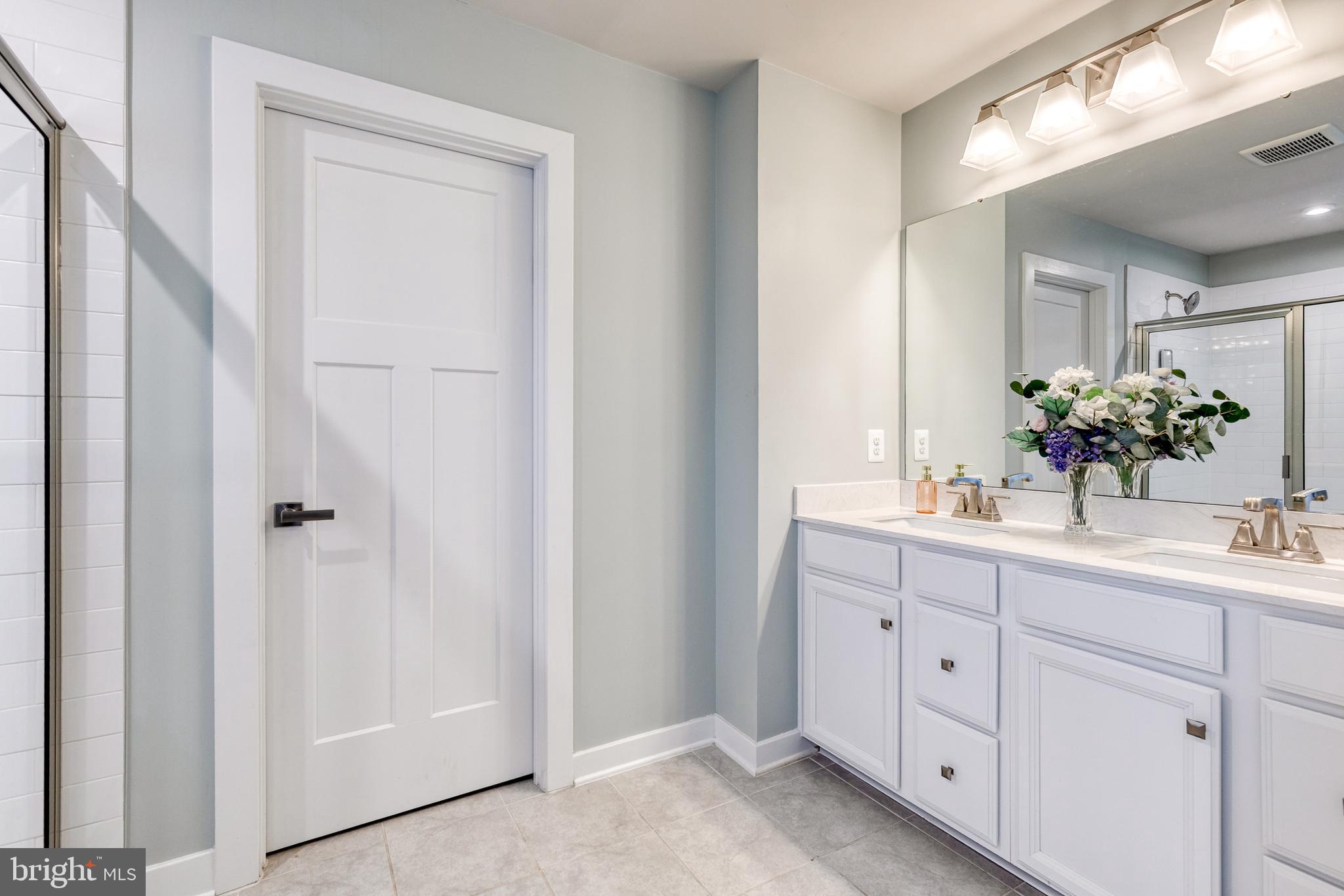 6003 Valentine Way Hanover, MD 21076 - Photo 38 of 52 a bathroom with a sink and a mirror