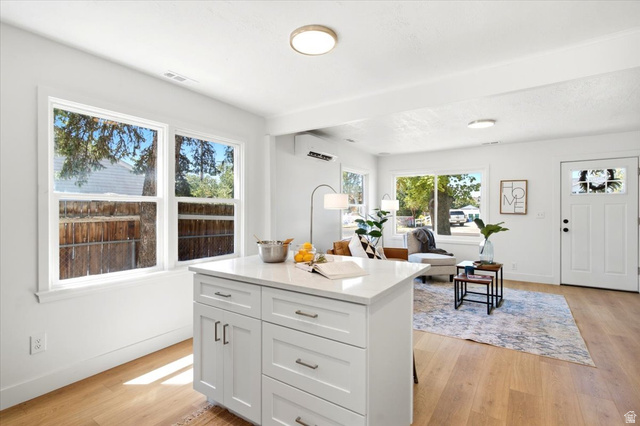 307 Flint Street Layton, UT 84041 - Photo 6 of 13 Bright open-concept living space featuring a central island with white cabinetry and a light-toned countertop
