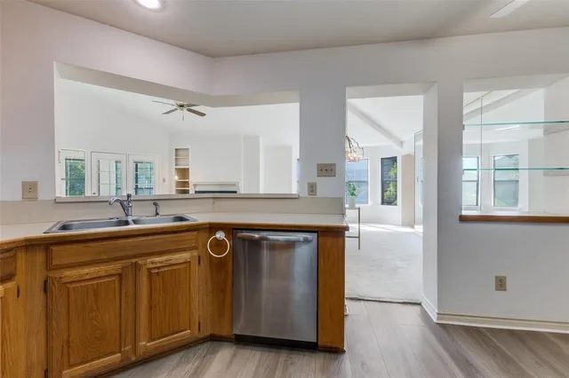 a kitchen with wooden cabinets and sink