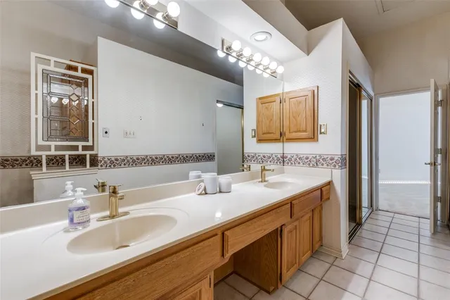 a bathroom with a sink double vanity granite and a mirror