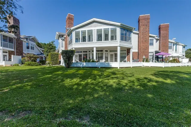 a front view of a house with a garden and plants