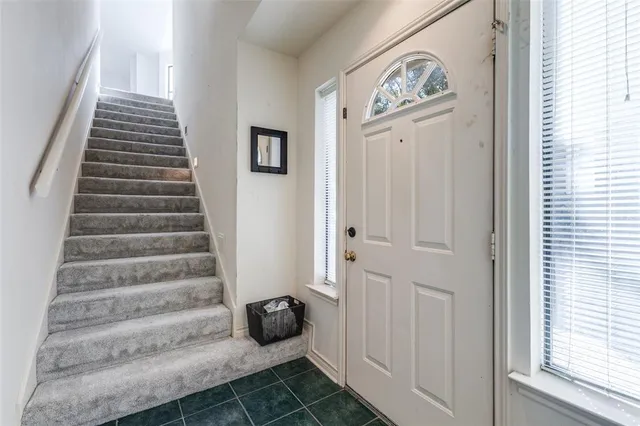 a view of entryway with stairs and a window
