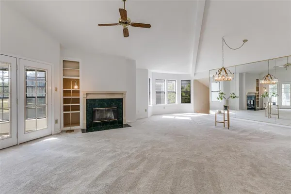 a view of a livingroom with a fireplace and window