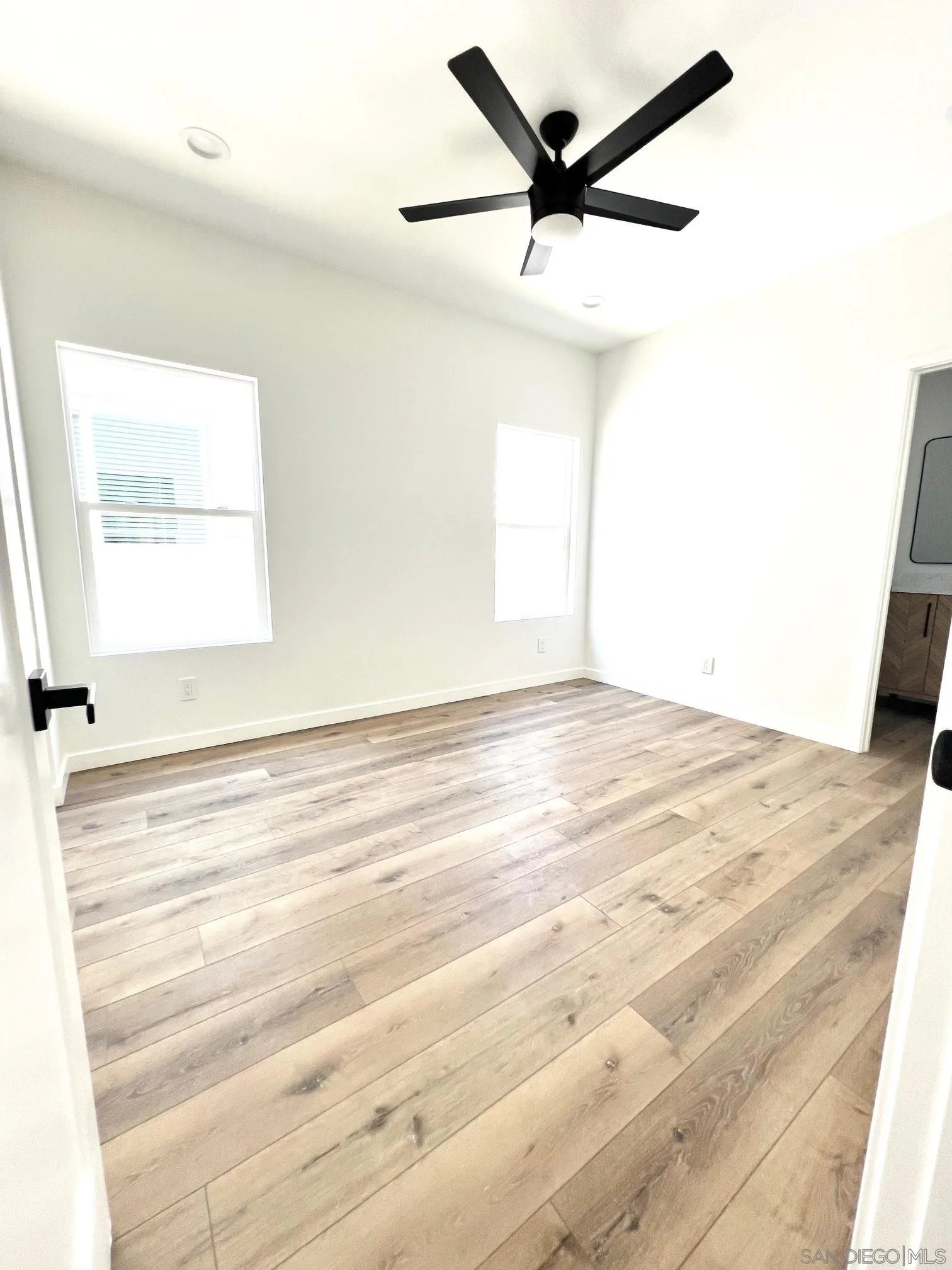 4922 Muir Avenue San Diego, CA 92107 - Photo 20 of 56 a view of a room with a ceiling fan and wooden floor