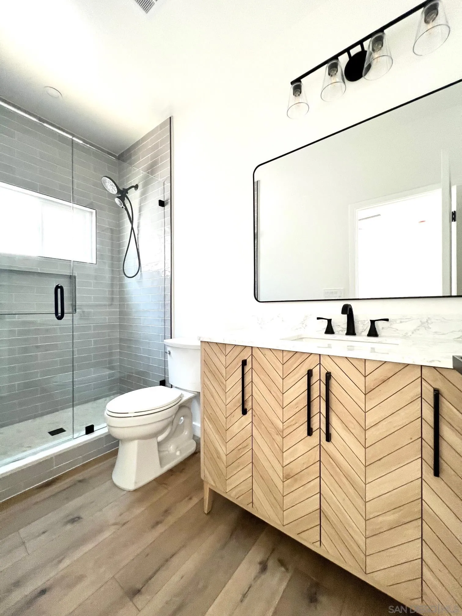 4922 Muir Avenue San Diego, CA 92107 - Photo 22 of 56 a white toilet sitting next to a bathroom sink