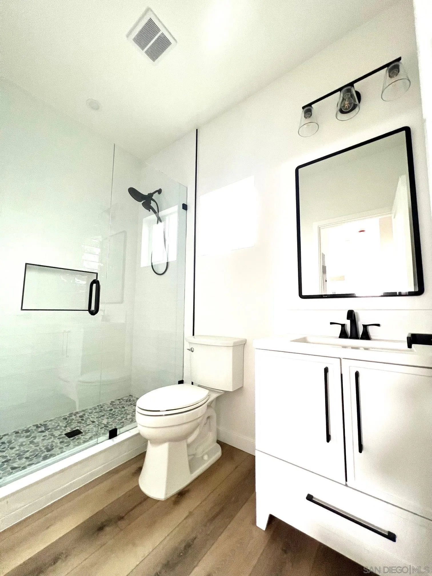 4922 Muir Avenue San Diego, CA 92107 - Photo 24 of 56 a bathroom with a toilet sink and mirror
