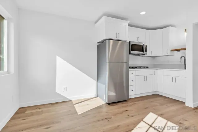 a bed sitting in a bedroom next to a window