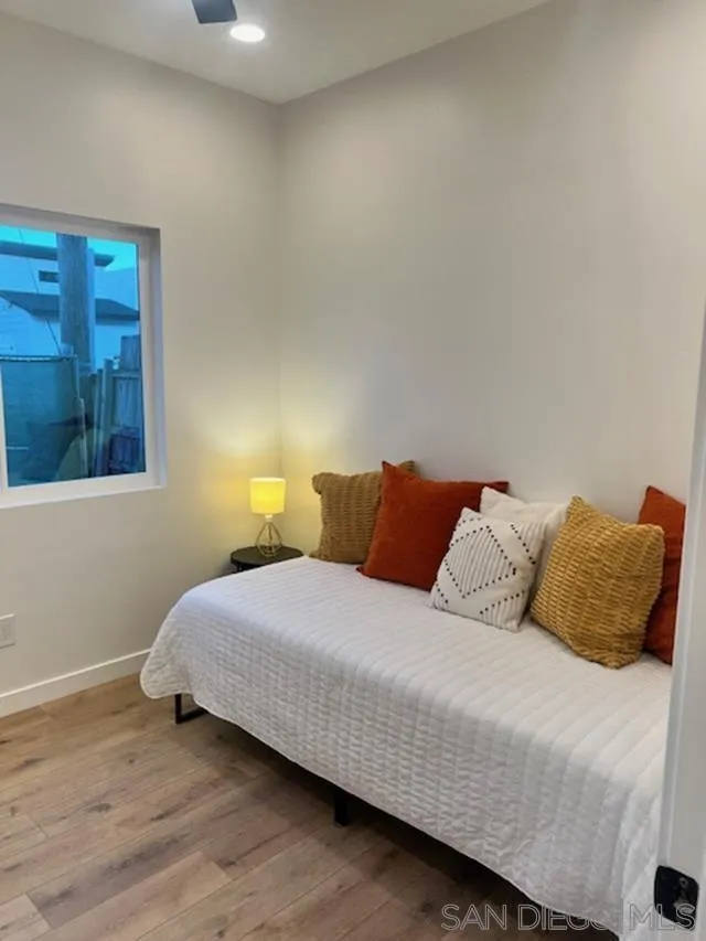 4922 Muir Avenue San Diego, CA 92107 - Photo 32 of 56 a bedroom with a bed and a night stand