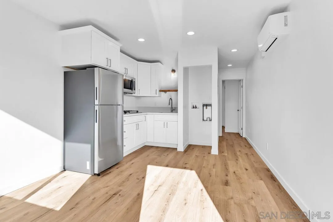 4922 Muir Avenue San Diego, CA 92107 - Photo 38 of 56 a kitchen with white cabinets and stainless steel appliances