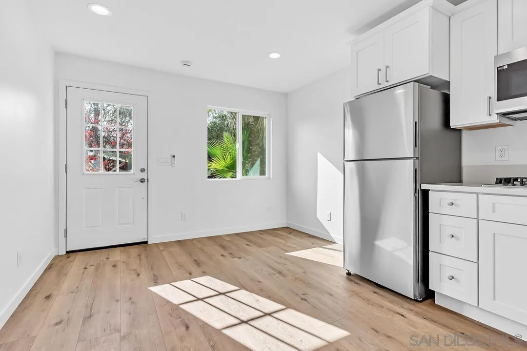 4922 Muir Avenue San Diego, CA 92107 - Photo 39 of 56 a view of kitchen with refrigerator cabinets and wooden floor