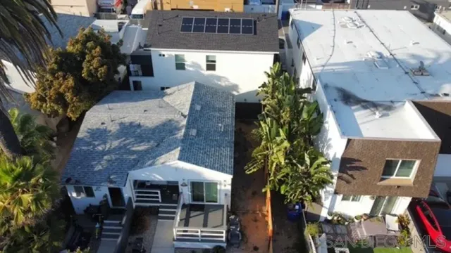 an aerial view of multiple houses with a yard
