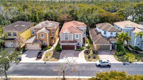 an aerial view of a houses with yard