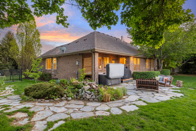 6208 West Bull River Road Highland, UT 84003 - Photo 67 of 90 Expansive backyard featuring a natural stone patio, manicured lawn, mature trees, and a brick exterior